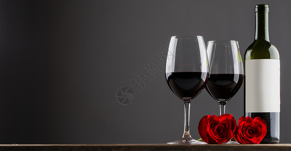 红酒玫瑰两杯红酒心形玫瑰放木桌上,灰色的图片