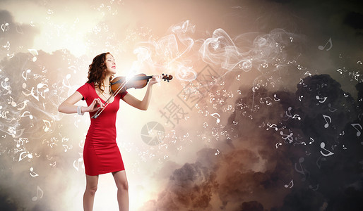 女小提琴手轻迷人的女人穿着红色连衣裙拉小提琴图片