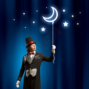 戴帽子的魔术师男子魔术师的形象与气球的颜色背景图片