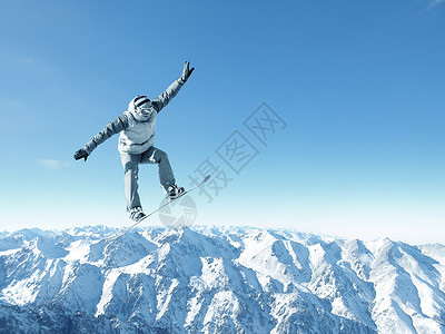 滑雪者晴朗的蓝天上跳高滑雪运动背景图片