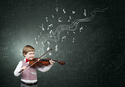 拉小提琴男孩他很少天赋可爱的男孩穿着红色的蝴蝶结,拉小提琴背景