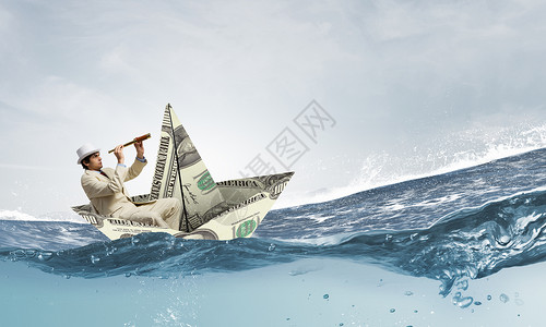 商人用美元钞票的船成功的商人金融海洋中乘船航行高清图片