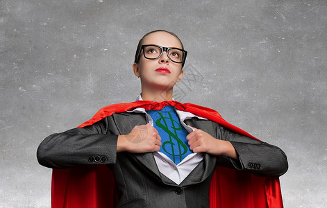 超人标志素材她超级金融家轻的女人表现得像超级英雄,胸前美元的标志背景