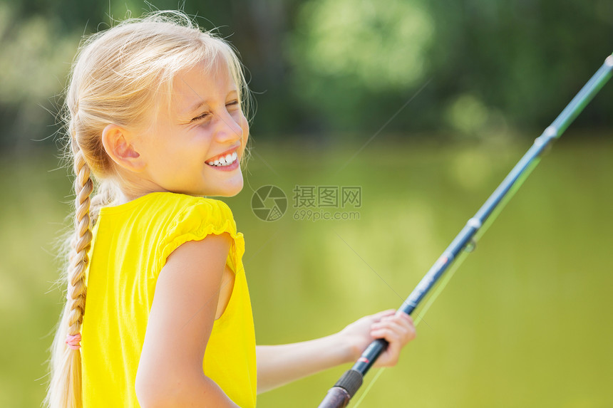 坐银行钓鱼的可爱女孩的肖像图片