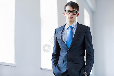 轻成功的商人戴眼镜的英俊自信的商人的形象图片