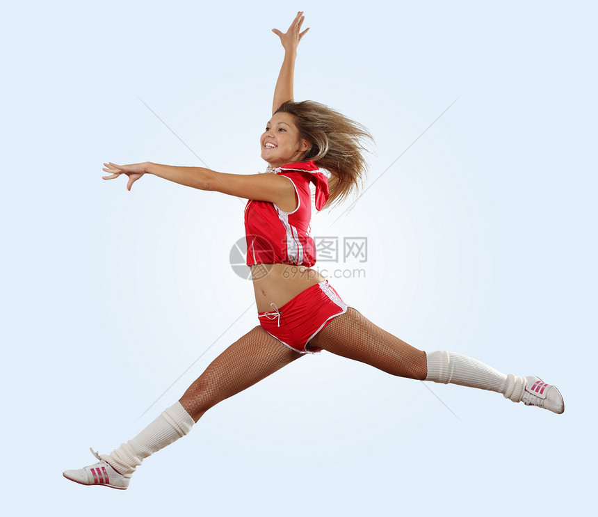 啦啦队长女孩跳穿制服的拉拉队长白色的空中跳得很高图片