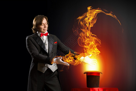 戴帽子的魔术师魔术师着帽子,火焰烟雾熄灭的形象图片
