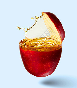 苹果汁飞溅中多汁苹果的图像清爽健康图片