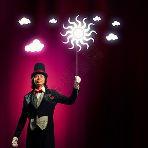 戴帽子的魔术师男子魔术师的形象与气球的颜色背景男人高清图片素材