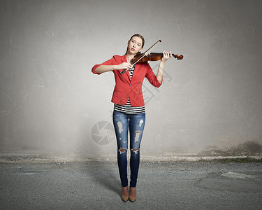 漂亮的女人帕利小提琴穿着红色夹克的轻漂亮女人拉小提琴图片