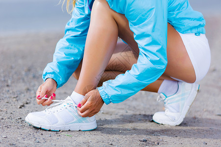 户外跑步轻健康的女孩系运动鞋的鞋带背景图片