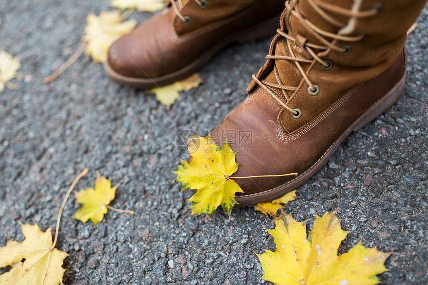 季节,鞋类人的女脚靴子与秋天的叶子地上图片