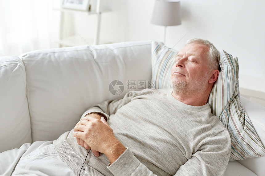 老休息舒适人的老人睡家里的沙发上图片
