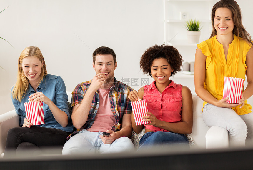 友谊,垃圾食品,人娱乐活动快乐的朋友家里吃爆米花看电视图片