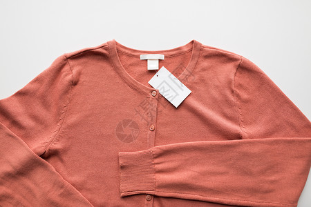 粉红色按钮标签服装,穿着,时尚物品的羊毛衫与价格标签背景