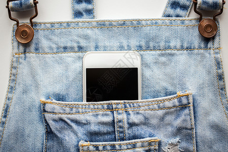 技术通信智能手机口袋牛仔工作服牛仔工作服口袋里的智能手机图片