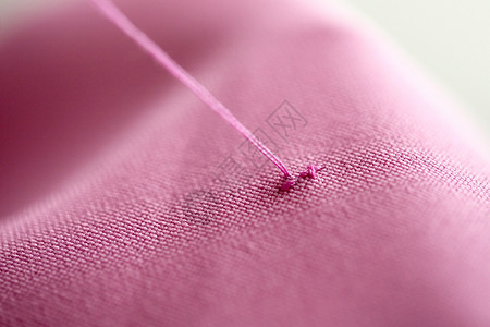 十字绣,针线裁剪线缝粉红色物上粉红色物上的十字绣线背景图片