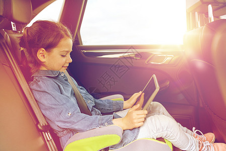 开汽车女孩交通,公路旅行,旅游,技术人的快乐的小女孩与平板电脑驾驶汽车安全座椅快乐的小女孩,平板电脑开车设计图片