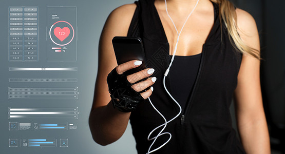运动,健身技术轻妇女与智能手机耳机听音乐健身房带智能手机耳机的女运动员图片