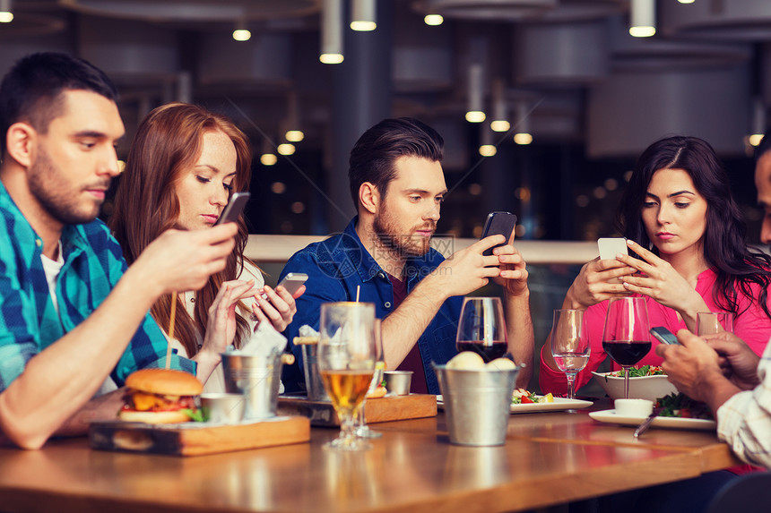 休闲,技术,生活方式人们的朋友与智能手机餐厅就餐智能手机的朋友餐厅用餐图片