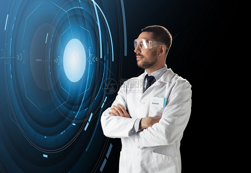 科学,未来技术人的男医生科学家穿白色实验室外套安全眼镜黑色背景与虚拟投影科学家实验室护目镜与虚拟投影图片