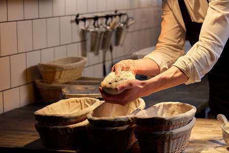 食物烹饪,烘焙人们的厨师包师把酵母包放入篮子,以便包店厨房上升包师带着包店的篮子里升背景图片