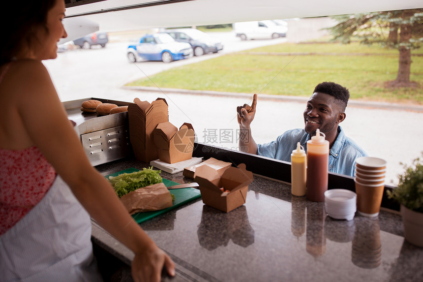 街头销售人们的快乐的非裔美国轻人食品卡车上订购炒锅非裔美国人食品卡车上点炒锅图片