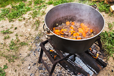 美味的匈牙利古拉什汤与辣椒牛肉大自然中的传统烹饪锅着火了背景图片