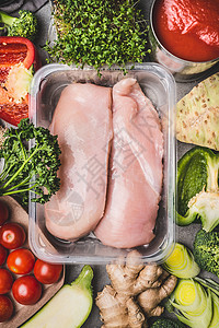 生机鸡胸片塑料包装托盘与各种蔬菜美味烹饪,顶部视图健康食品运动饮食营养背景
