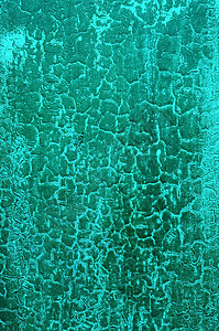旧开裂的蓝绿色混凝土墙,纹理背景图片