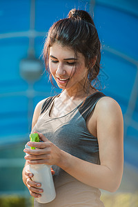 健身美丽的女人喝水出汗后,夏季炎热的日子城市锻炼女运动员锻炼后图片