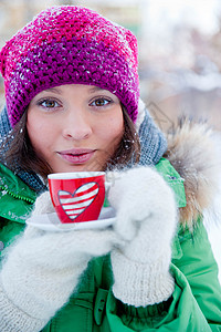 穿冬装的轻女人喜欢喝咖啡图片