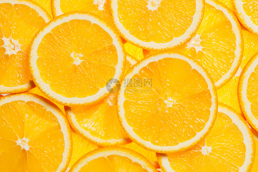 彩色橙色柑橘类水果片背景背光五颜六色的橙色水果片图片