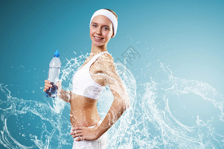 运动女人纯净水运动中的轻漂亮女人戴着瓶纯净水图片