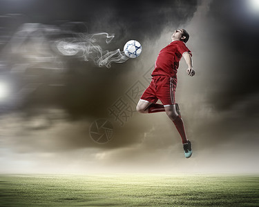 足球运动员击球足球运动员穿着红色衬衫体育场击球图片