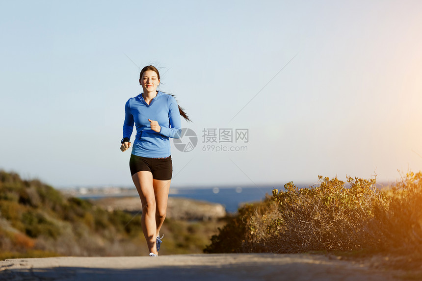 运动跑步者海滩上慢跑锻炼适合女健身模型沿海洋慢跑图片