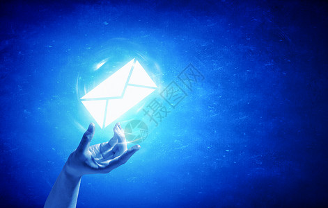 电子邮件标志人的手电子邮件图标手掌上的蓝色背景图片