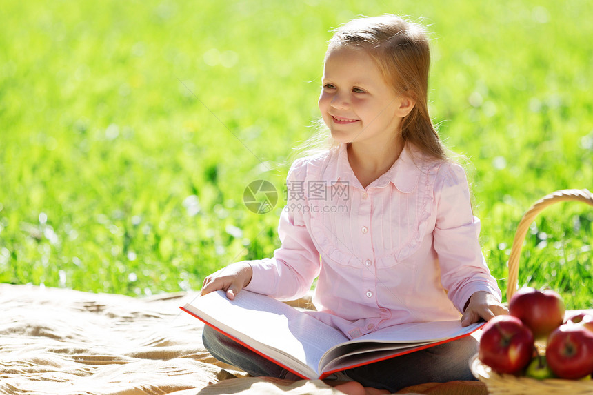 孩子带着书夏天的公园野餐公园里的女孩图片
