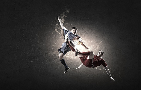 足球运动员两名足球运动员跳跃中争球背景图片