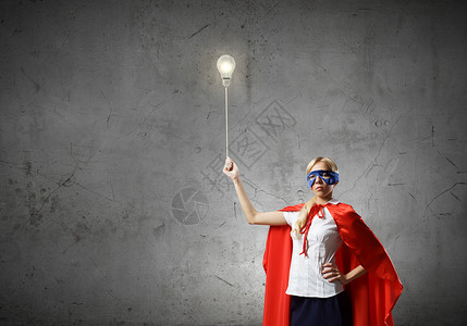 超级女人穿着超级英雄服装的轻女人手里着灯泡气球图片