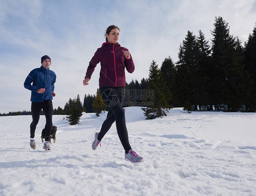 你的女人森林里的雪地上户外慢跑,健康的冬季生活方式娱乐活动图片
