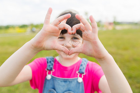 夏天,童,休闲,爱人的快乐的小女孩绿色的夏天田野上心形的手势图片