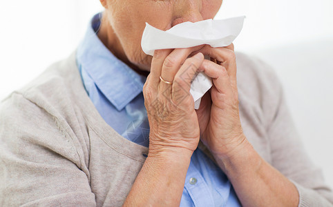 人的鼻子保健,流感,卫生,龄人的密切生病的老妇女家里鼻子纸巾背景