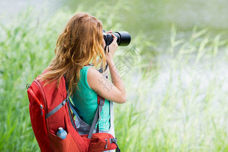 旅行,旅游,远足,爱好人的轻的女人带着背包相机户外拍照图片
