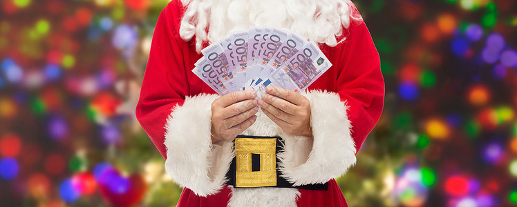 诞节,假日,胜利,货币人的诞老人与欧元的钱灯光背景图片
