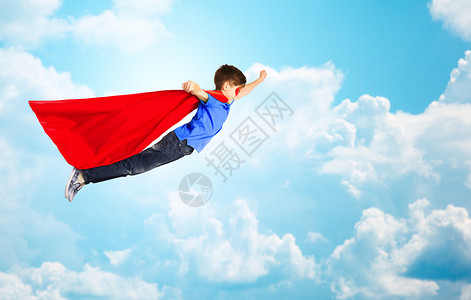 幸福,自由,童,运动人的男孩穿着红色超级英雄斗篷具蓝天云彩的背景下空中飞行图片