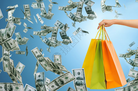 消费主义袋子人,消费主义,金融销售特写女手购物袋蓝色背景金钱雨设计图片