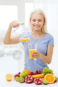 健康饮食,素食,饮食,排人们的观念微笑的女人家里把果汁水壶倒杯子里图片