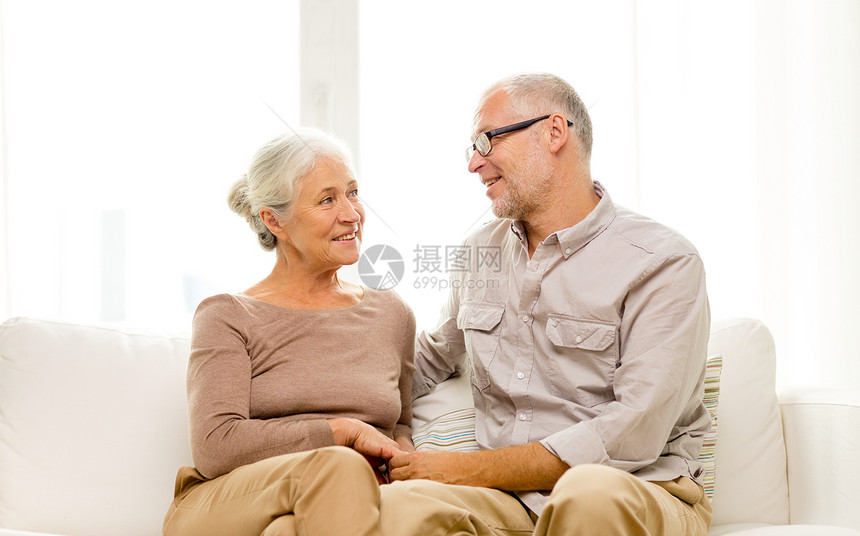 家庭,假期,龄人的幸福的老夫妇坐家里的沙发上图片