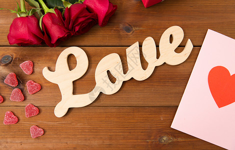 浪漫,情人节假期的字爱,礼品盒,红玫瑰贺卡与心形糖果木材上图片